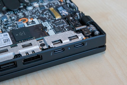 The USB-C ports are to be detached from the mainboard.